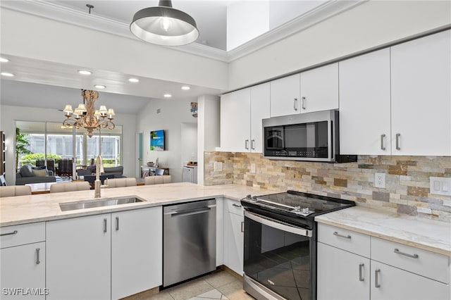 kitchen featuring a sink, appliances with stainless steel finishes, backsplash, and recessed lighting