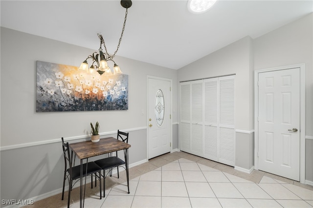 dining space with an inviting chandelier, baseboards, vaulted ceiling, and light tile patterned flooring