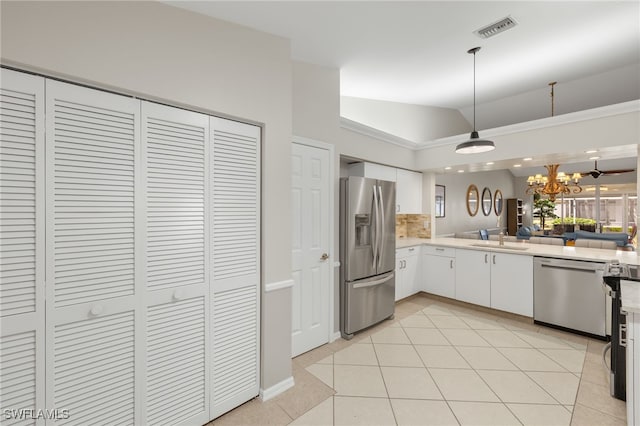 kitchen featuring white cabinets, appliances with stainless steel finishes, a sink, light countertops, and visible vents