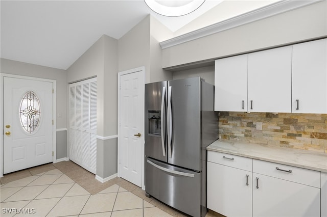 kitchen featuring white cabinetry, tasteful backsplash, vaulted ceiling, and stainless steel fridge with ice dispenser