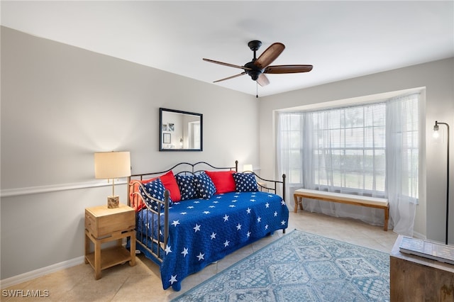 bedroom featuring tile patterned floors, baseboards, and ceiling fan