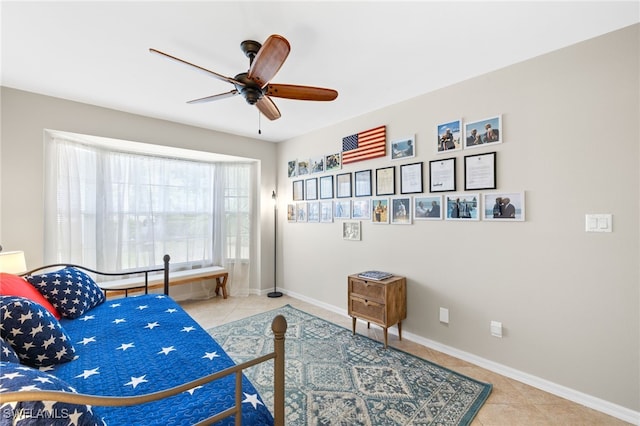 bedroom featuring tile patterned floors, ceiling fan, and baseboards