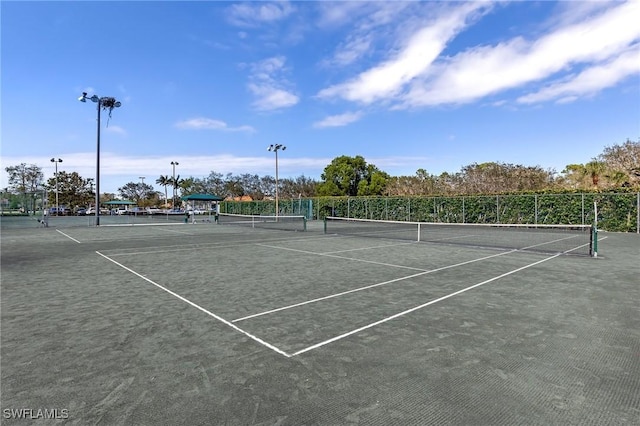 view of sport court featuring fence