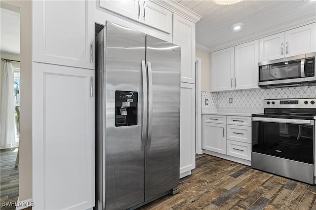 kitchen with stainless steel appliances, white cabinetry, dark wood-style floors, backsplash, and recessed lighting