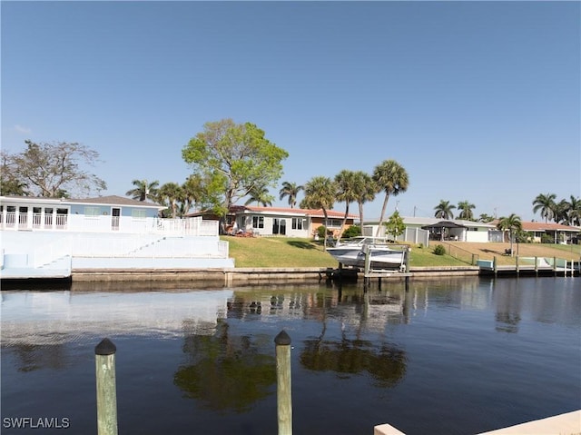 dock area featuring a water view, a residential view, and fence