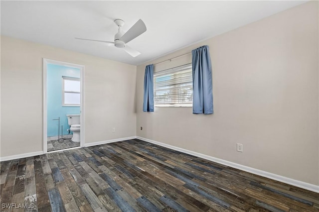 spare room featuring hardwood / wood-style floors, a ceiling fan, healthy amount of natural light, and baseboards