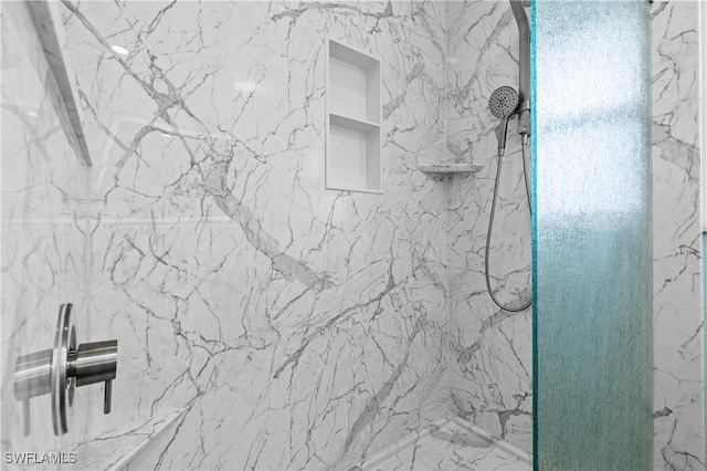bathroom with a marble finish shower