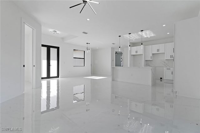 unfurnished living room with french doors, a ceiling fan, recessed lighting, and marble finish floor