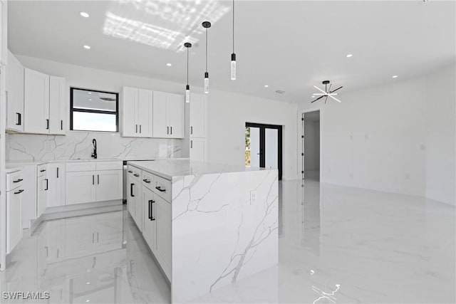 kitchen featuring a healthy amount of sunlight, a center island, recessed lighting, and marble finish floor