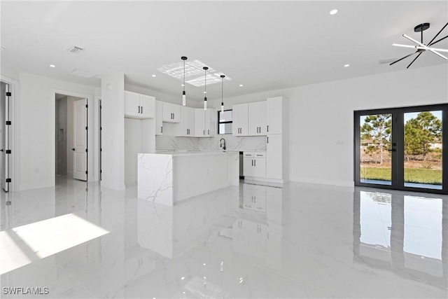 unfurnished living room featuring french doors, visible vents, a sink, marble finish floor, and recessed lighting