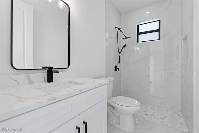 full bath with toilet, a marble finish shower, and vanity
