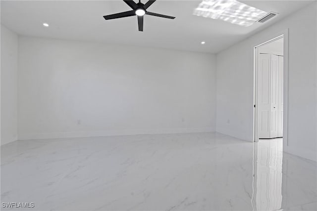 unfurnished room featuring ceiling fan, visible vents, baseboards, marble finish floor, and recessed lighting