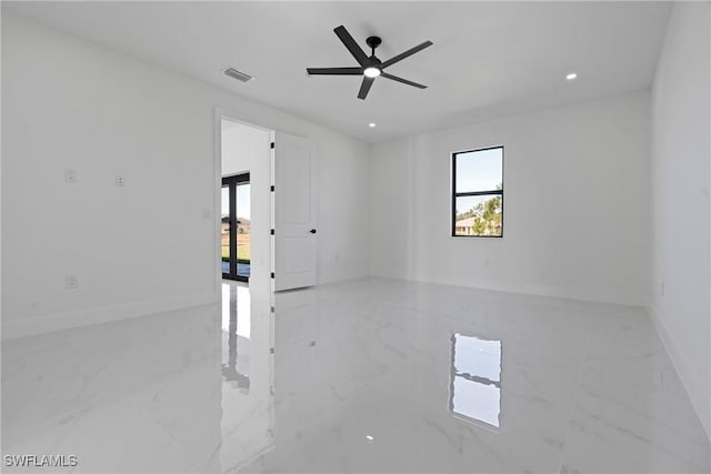 spare room with ceiling fan, visible vents, baseboards, marble finish floor, and recessed lighting