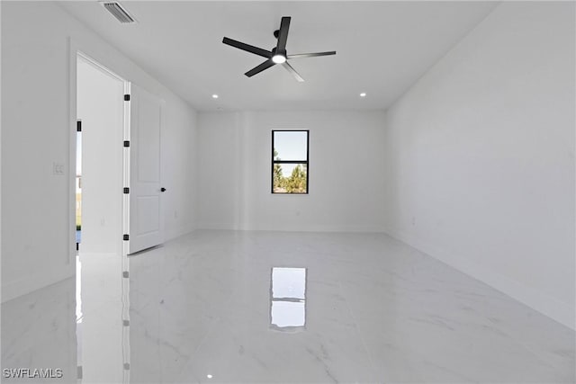 empty room featuring ceiling fan, marble finish floor, recessed lighting, baseboards, and visible vents