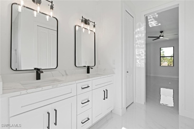 full bathroom featuring double vanity, a sink, marble finish floor, and a ceiling fan