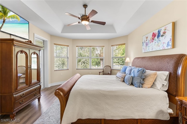 9280 Triana Ter Unit 234, Fort Myers, FL 33912 - bedroom with a raised ceiling, wood finished floors, a ceiling fan, access to outside, and baseboards