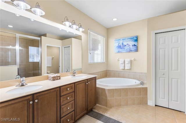 9280 Triana Ter Unit 234, Fort Myers, FL 33912 - bathroom with a closet, tile patterned flooring, a bath, a stall shower, and double vanity