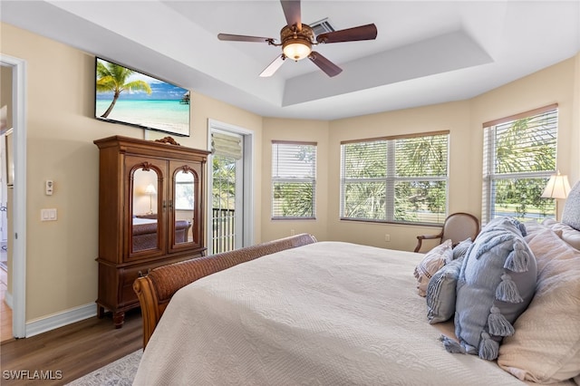 9280 Triana Ter Unit 234, Fort Myers, FL 33912 - bedroom with wood finished floors, a raised ceiling, baseboards, and a ceiling fan