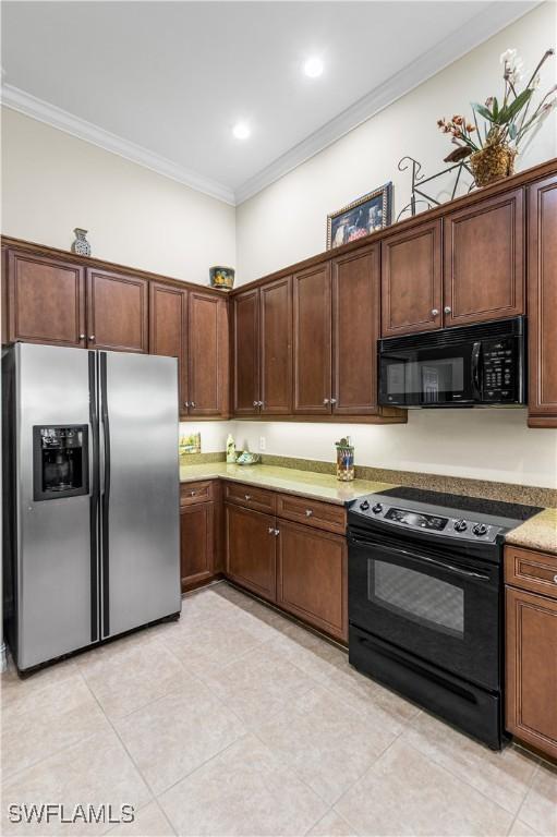 9280 Triana Ter Unit 234, Fort Myers, FL 33912 - kitchen featuring black appliances, ornamental molding, light tile patterned flooring, and light stone countertops