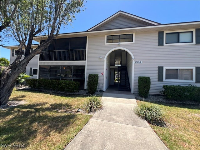 8080 S Woods Cir Unit 11, Fort Myers, FL 33919 - view of front of house with stairs and a front lawn