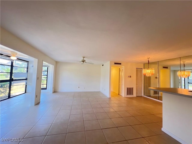 8080 S Woods Cir Unit 11, Fort Myers, FL 33919 - unfurnished living room with tile patterned flooring, visible vents, and a healthy amount of sunlight