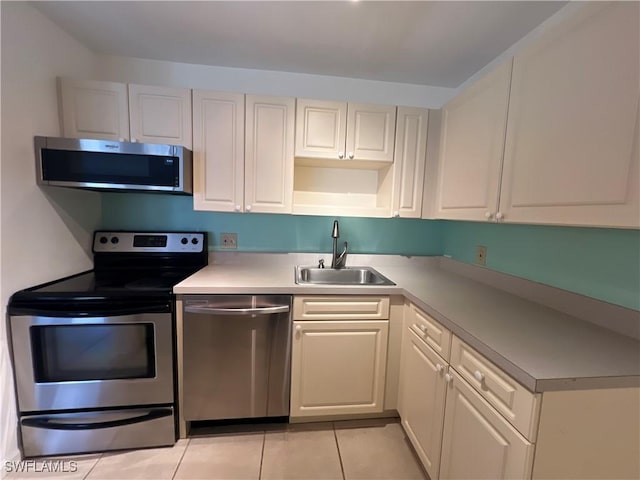 8080 S Woods Cir Unit 11, Fort Myers, FL 33919 - kitchen with light countertops, stainless steel appliances, light tile patterned flooring, and a sink