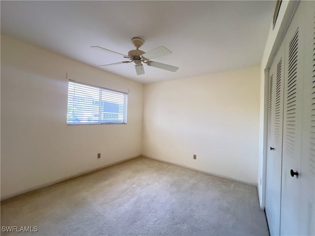 8080 S Woods Cir Unit 11, Fort Myers, FL 33919 - unfurnished bedroom with a ceiling fan, light carpet, and a closet