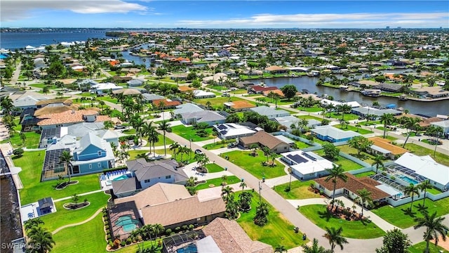 bird's eye view featuring a water view and a residential view