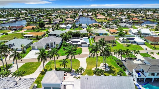 drone / aerial view featuring a residential view and a water view