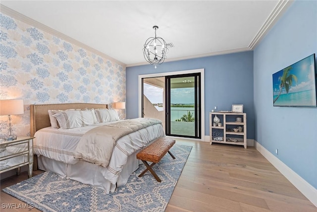 1247 Blue Hill Creek Dr, Marco Island, FL 34145 - bedroom with wallpapered walls, access to exterior, wood finished floors, a chandelier, and baseboards