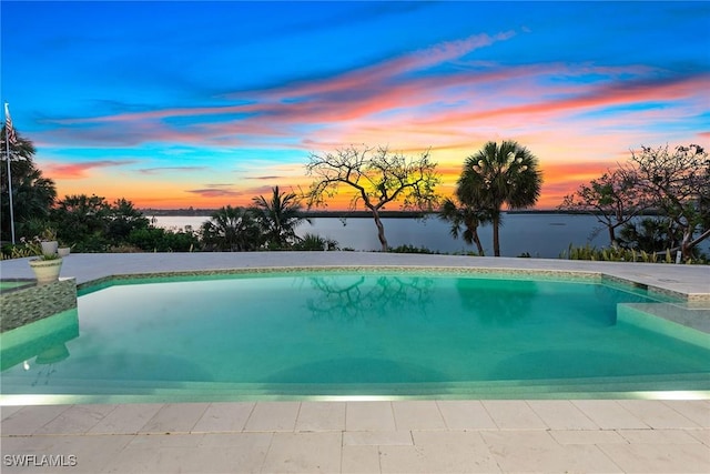 1247 Blue Hill Creek Dr, Marco Island, FL 34145 - pool at dusk with an outdoor pool and a water view