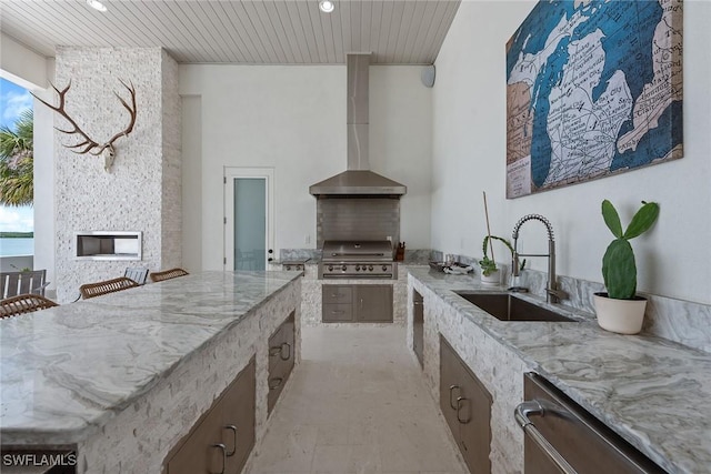 1247 Blue Hill Creek Dr, Marco Island, FL 34145 - kitchen featuring a sink, wall chimney range hood, wooden ceiling, light stone counters, and recessed lighting