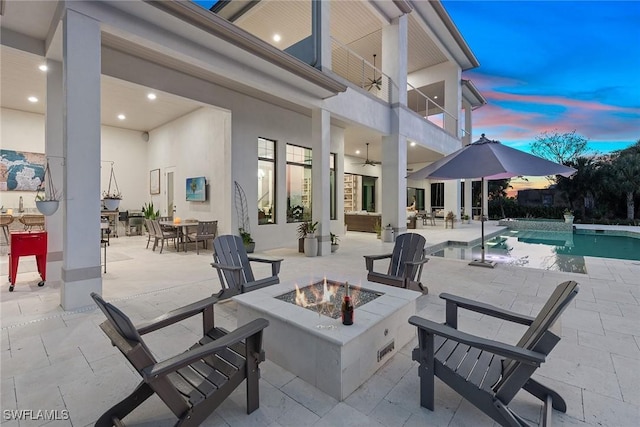 1247 Blue Hill Creek Dr, Marco Island, FL 34145 - view of patio featuring a balcony, an outdoor fire pit, a ceiling fan, an outdoor pool, and outdoor dining space