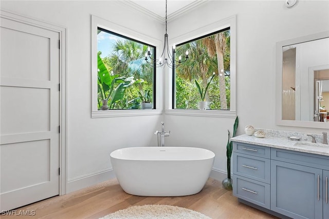 1247 Blue Hill Creek Dr, Marco Island, FL 34145 - full bath with wood finished floors, a freestanding bath, vanity, and crown molding