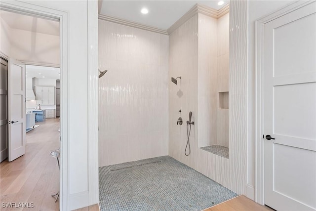 1247 Blue Hill Creek Dr, Marco Island, FL 34145 - bathroom featuring a tile shower, wood finished floors, and ornamental molding