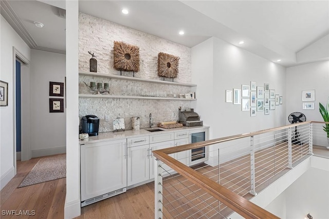 1247 Blue Hill Creek Dr, Marco Island, FL 34145 - indoor wet bar featuring light wood-type flooring, recessed lighting, backsplash, wine cooler, and baseboards