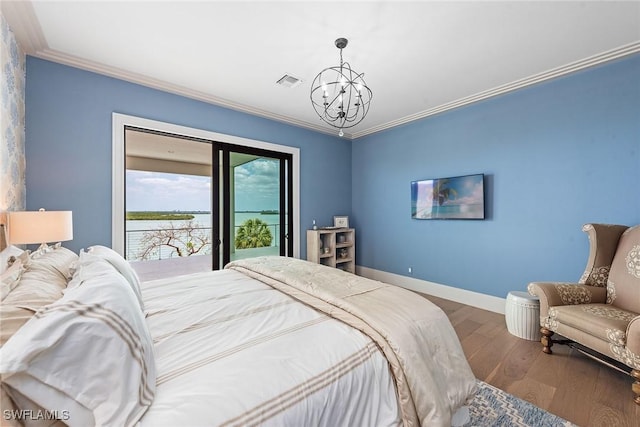 1247 Blue Hill Creek Dr, Marco Island, FL 34145 - bedroom with a chandelier, access to outside, wood finished floors, ornamental molding, and baseboards