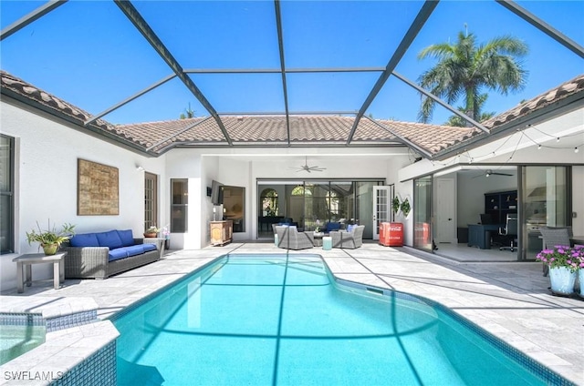 back of property featuring a ceiling fan, a patio area, a tile roof, and an outdoor hangout area