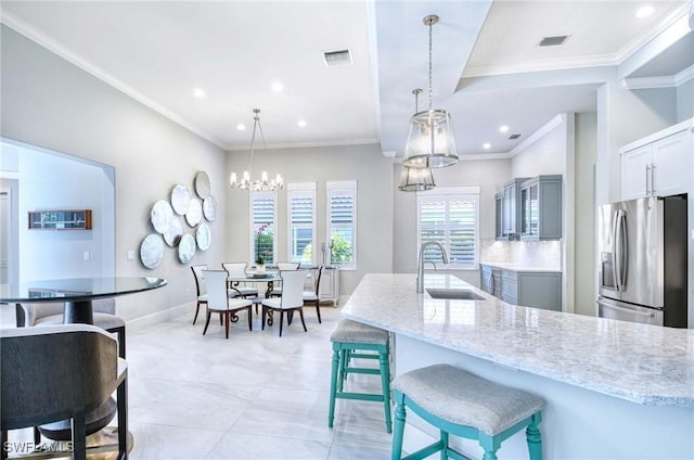 kitchen featuring a chandelier, visible vents, a sink, and stainless steel fridge with ice dispenser