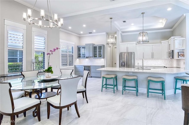 dining space with crown molding and an inviting chandelier