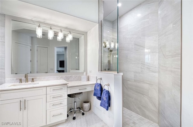 bathroom with a walk in shower and vanity