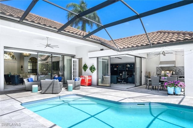 back of house with an outdoor living space, ceiling fan, a patio area, and a tile roof