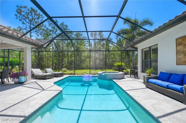 view of swimming pool featuring a pool with connected hot tub, glass enclosure, an outdoor living space, and a patio area