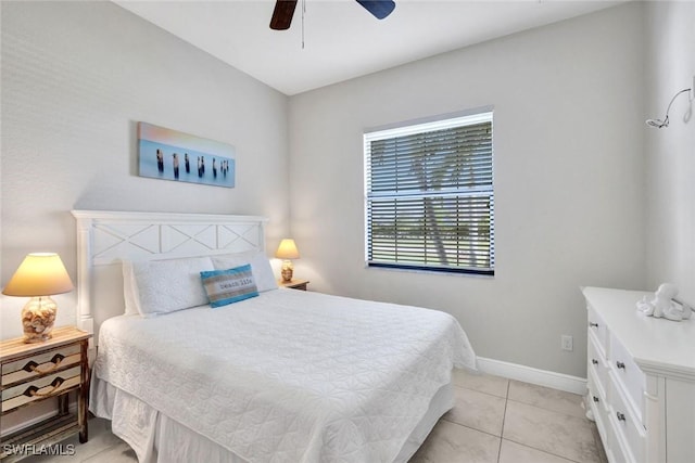bedroom featuring light tile patterned floors, baseboards, and ceiling fan