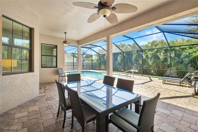 view of patio featuring outdoor dining space, ceiling fan, an outdoor pool, and glass enclosure