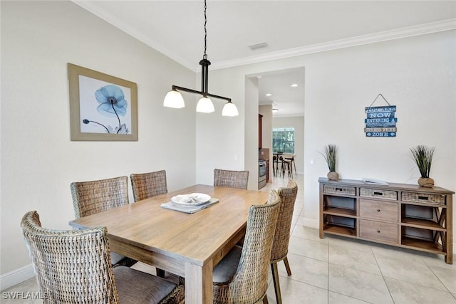 dining room featuring crown molding, baseboards, and light tile patterned floors