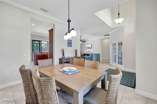 dining room with crown molding, light tile patterned flooring, ceiling fan, and baseboards