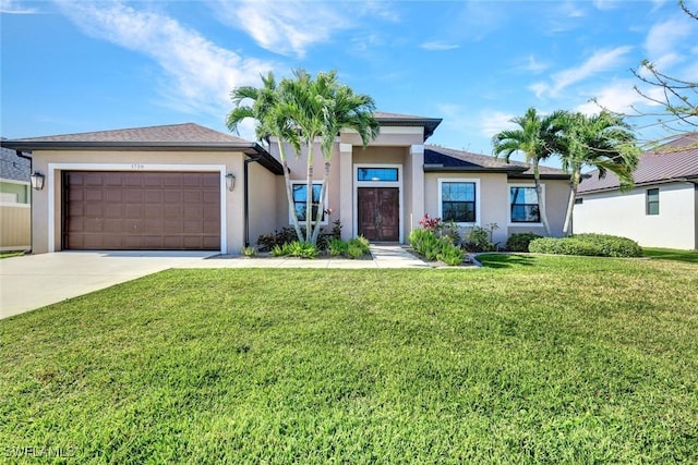 view of front of property with driveway, an attached garage, a front yard, and stucco siding