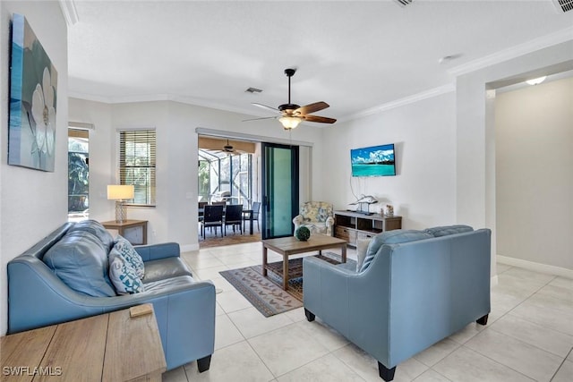 living room featuring a ceiling fan, baseboards, ornamental molding, and light tile patterned flooring