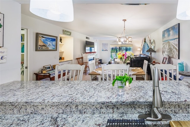 12130 Kelly Greens Blvd Unit 91, Fort Myers, FL 33908 - dining area featuring an inviting chandelier and visible vents